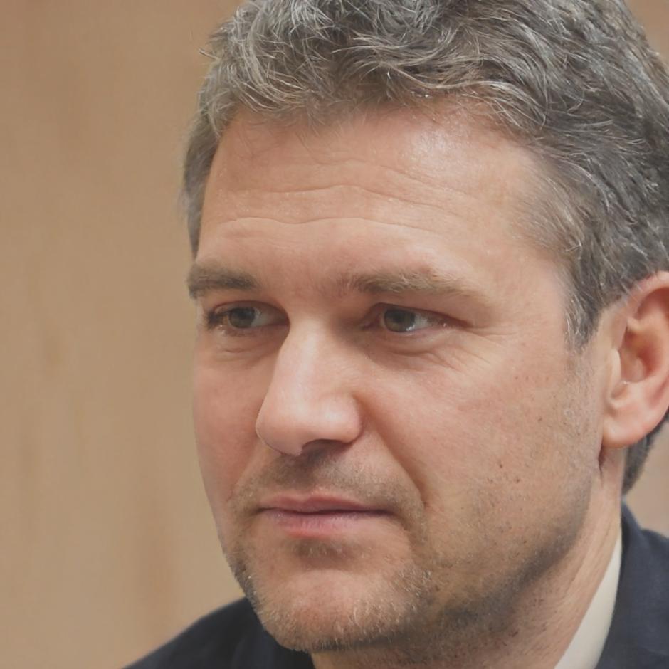 Senior ecologist reviewing biodiversity monitoring data for precision farming application